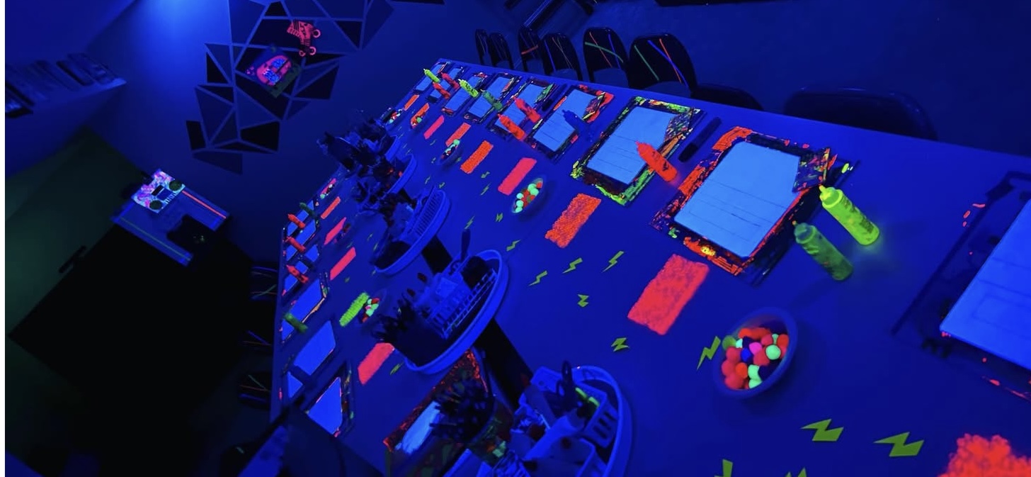 Blacklight glow art party setup at Little Blueprints Art Studio