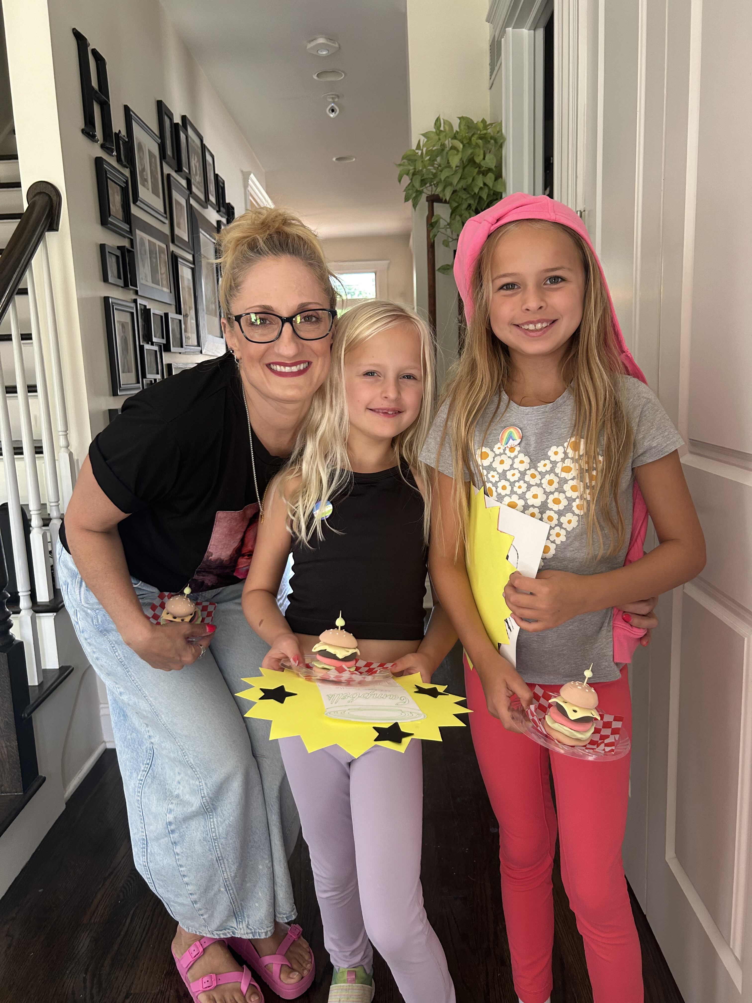 Molly with kids showing off their finished art projects