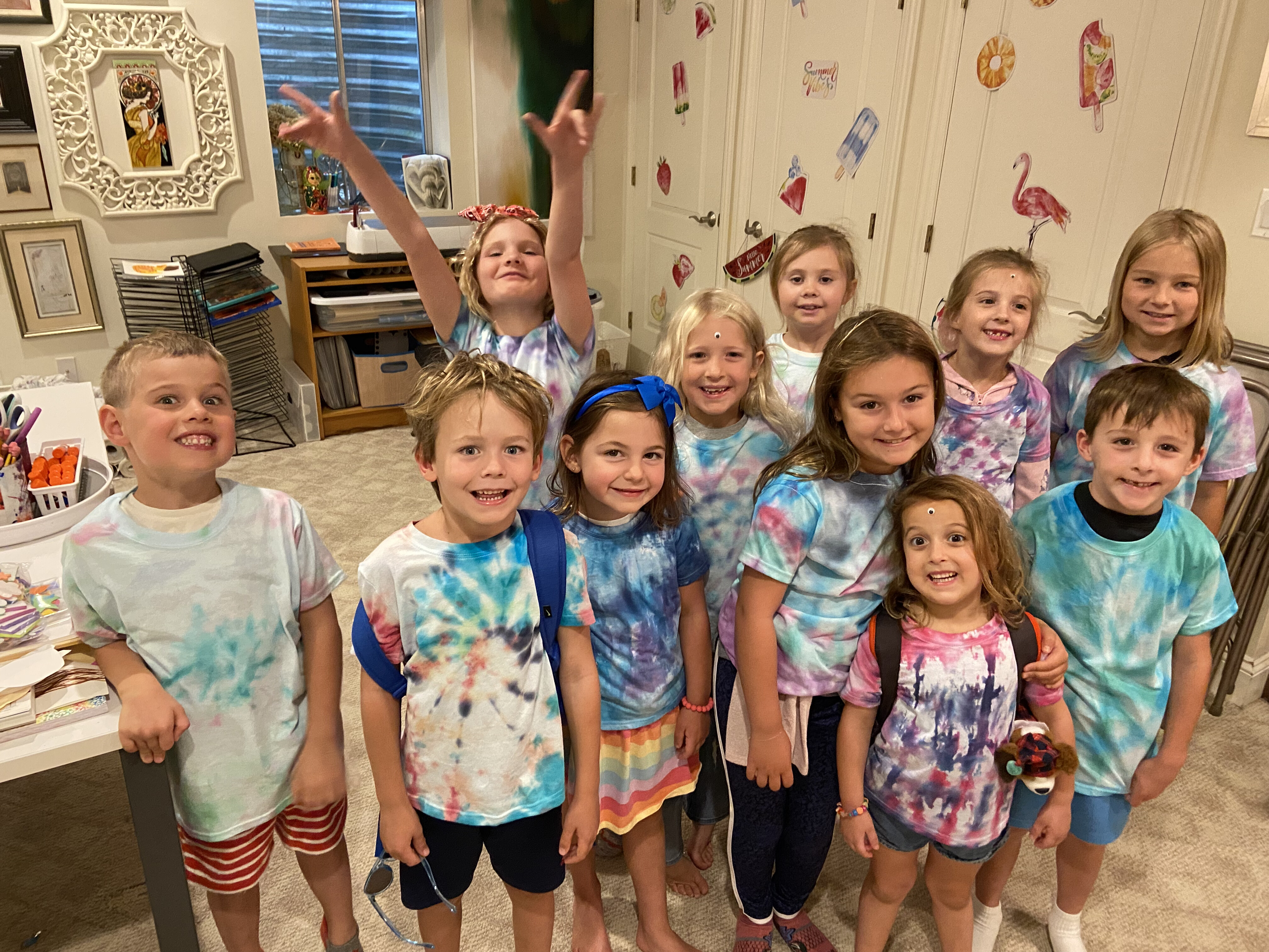 Indoor camp group showing off tie-dye creations